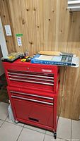 Front view of red Craftsman tool chest with tools on top