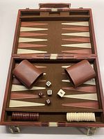 Full view of vintage travel backgammon game set with cinnamon striped felt board, cinnamon and cream pieces, dice, throwers, and doubling cube inside case.