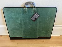 Full front view of the green suede portfolio showing overall condition and size.
