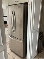 Exterior front view of stainless steel French door refrigerator with bottom freezer drawer