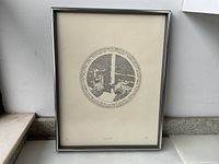 Framed black and white print featuring circular Hebrew text and figures, numbered 12/250.