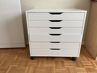 Front view of the white IKEA drawer unit showing five drawers and casters.