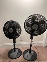 Two black WeatherWorks floor fans side by side showing size and overall appearance.