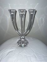 Clear crystal 3-stick candelabra candle holder on a white cloth background, showing the full item and crystal refraction effects.