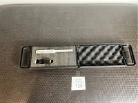 Microphone and microphone stand clip inside a black plastic hard case with foam insert.