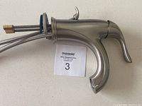 Side view of Danze bathroom faucet showing ergonomic handle and connection hoses.