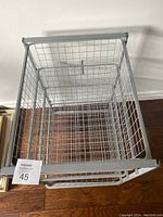 Top-down view showing open wire mesh drawer with grid pattern and metal frame.