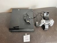 Top view showing PS4 console, power cord, controller on charging dock with AC adapter and USB cable