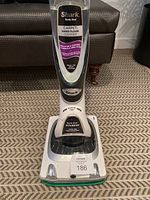 Front angle showing the full body of the Shark Sonic Duo Carpet & Hard Floor Cleaner on a patterned rug.