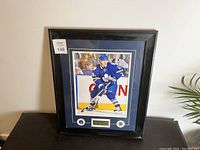 Framed signed print of Phil Kessel in Toronto Maple Leafs uniform with autograph and plaque under the image.