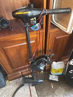 Full view of trolling motor showing head, shaft, propeller, wiring and clamp mount