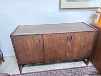 Front view of entire cabinet showing dark walnut veneer finish and door configuration