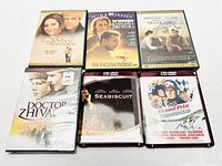 Photo of 6 movie discs with titles The Way We Were, The English Patient, Out of Africa, Doctor Zhivago, Seabiscuit (HD DVD), The Great Race (HD DVD).