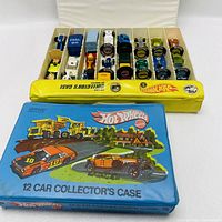 Yellow interior tray loaded with assorted Hot Wheels cars, blue vinyl case beneath
