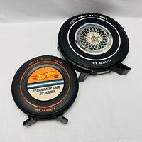 Two tire-shaped Mattel carrying cases for Hot Wheels cars, exterior view