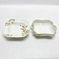 Two white porcelain Limoges bowls with floral decoration side by side, showing shape and design details.