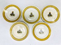 Top-down photo shows all five Wedgwood plates arranged in a semi-circle, highlighting the consistent design of yellow dotted borders and basket center.
