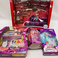 Photo showing all items: boxed Trolls playset with car and accessories, Trolls Media Lounge playset with doll and furniture, FairyTale boxed doll, and Sky Dancers boxed flying fairy doll.