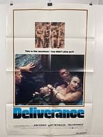 Photo of Deliverance movie poster showing photographic images and blue and brown colors with folds and spot in middle