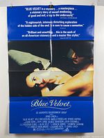 Blue Velvet movie poster with quotes and film credits, laying flat with visible fold lines and minor blemishes