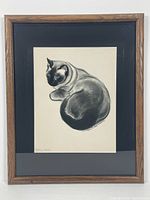 Full view of the framed print showing the Siamese cat in black and white with blue eyes, with natural wood frame and black matte.