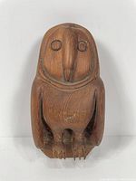 Front view of the carved wooden owl sculpture highlighting overall shape and carved details.