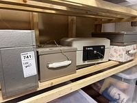 Photo of four metal safes including a beige Sentang 160 safe with a key, gray fire file with white handle, and two other metal safes.