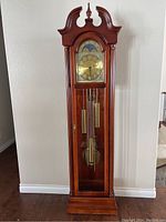 Full view of the Ridgeway Grandfather Clock with wooden body, glass door, brass pendulum and weights
