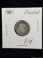 Obverse side of the 1891 Canada 10 cent silver coin in a white protective holder, showing Queen Victoria's profile and 'Canada 10C' inscription.