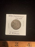 Front side of the 1898 Guatemala silver 2 Reales coin with seated figure.