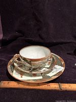 Cup, saucer, and dessert plate shown together with ruler for size reference (cup ~4in, saucer ~5.5in, plate ~7.5in)