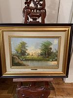 Frontal shot of the framed landscape oil painting showing the entire artwork and frame.