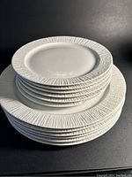 Stacked plates showing the textured brutalist matte edges on both dinner and salad plates.