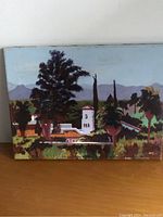 Front of the acrylic painting showing the landscape scene with architecture and trees against mountain background