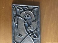 Close-up shot showing detail of the raised Celtic animal design on the plate