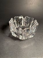 Front view of clear crystal crown-shaped bowl with faceted design and reflective surfaces showing shape and condition.
