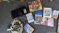 Lot contents including Samsung Blu-ray player, three DVDs, multiple books, Civil War multimedia collection, picture frame, and power cables.