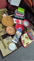 Overview of lot including stacked colorful plastic baskets, Canadian flag napkins or tablecloth, various dishes and trays, and packaged food picks.
