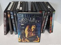 Front view of DVD cases showing titles including Salem Witch Trials in front.