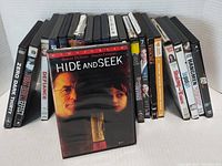 DVD movie cases arranged in one row showing spines and front cover of Hide and Seek in front.