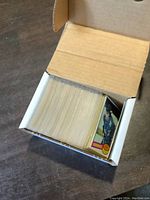 Top view of an open white box filled with 1977-78 O-Pee-Chee hockey cards, showing the thickness and condition of the cards inside.