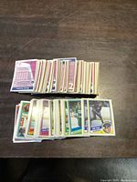 Multiple stacks of 1984 OPC hockey cards laid out on table, showing fronts with player photos and backs with statistics.