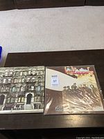 Both album covers displayed side by side on a table