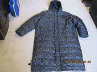 Full front view of jacket laid flat showing length and pattern.