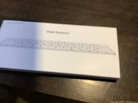 Top view of the boxed Apple Magic Keyboard showing the product image and name.