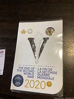 Front of sealed 2020 Canadian Royal Mint collector set with commemorative 'V' cutout and text about the 75th anniversary of the end of WWII.