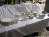 Group shot of entire Royal Doulton Paisley 5039 dinner and tea set arranged on tablecloth