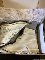 Pair of beige Timberland women's hiking boots in original box with branded wrapping paper.