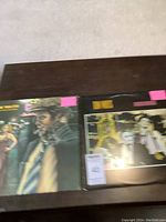 Photo of two album covers: The Heart of Saturday Night on left and Big Time sealed album on right with pink price stickers.