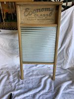 Full view of the vintage wooden washboard featuring the glass scrubbing surface and wooden frame.